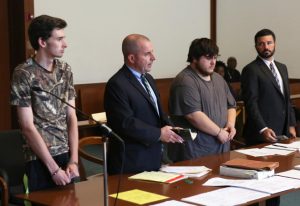 Kevin Norton, left, and James Stumbo, second from right, appear for their dangerousness hearing with attorneys John O'Neill, second from left, and Steven Goldwyn, right, at Boston Municipal Court, Tuesday, Sept. 1, 2015. The Iowa men, accused of making online threats of violence against the World Pokémon Championships competition in Boston, were ordered held without bail Tuesday after Judge Thomas Horgan rejected arguments by their lawyers that their comments amounted to idle online bravado. (Angela Rowlings/The Boston Herald via AP, Pool)