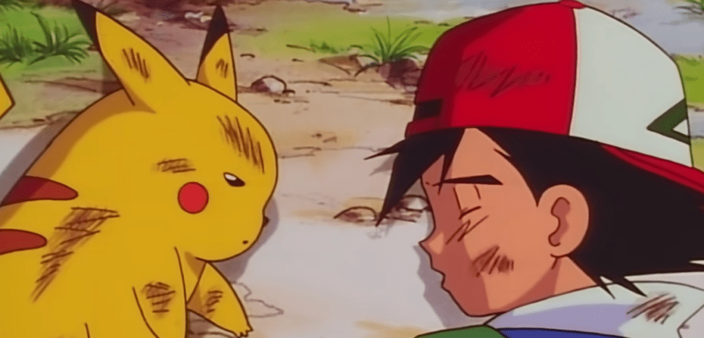 Pikachu e Ash stesi a terra stremati dall'attacco subito